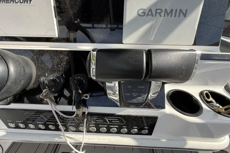 Slide: The Image of Control panel of a 1989 Wellcraft 302 Scarab boat with Garmin and Mercury equipment. - 95