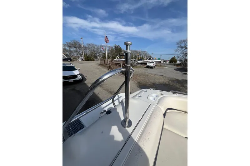 Slide: The Image of 2006 Tahoe 222 boat with stainless steel railing, parked outdoors under a clear sky. - 10