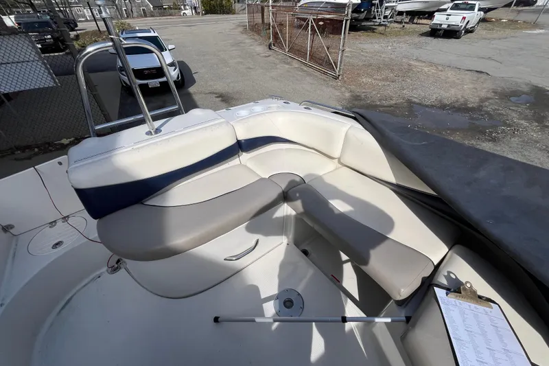 Slide: The Image of 2006 Tahoe 222 boat interior with beige seating and a clipboard on the deck. - 11