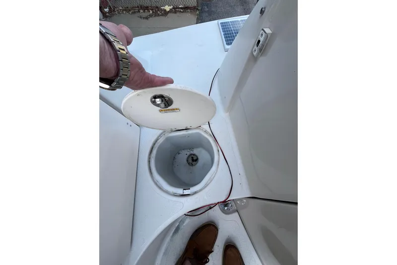 Slide: The Image of Open storage compartment on a 2006 Tahoe 222 boat deck. - 14