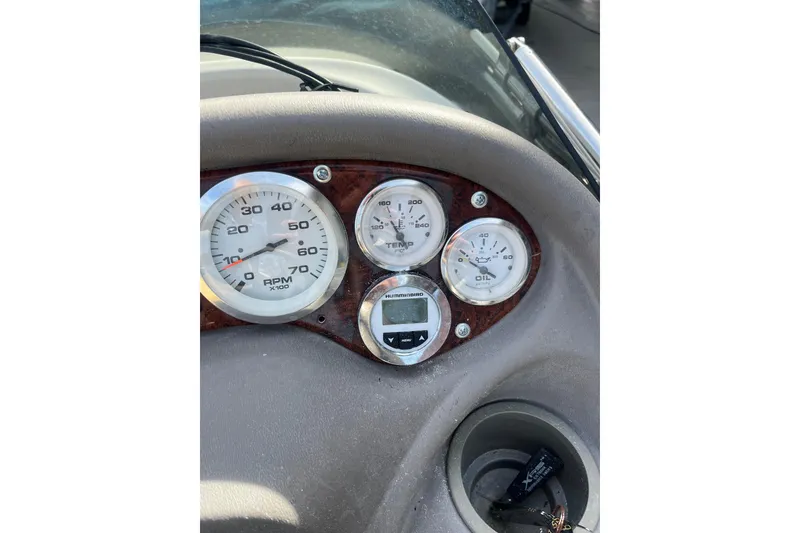 Slide: The Image of Dashboard of a 2006 Tahoe 222 boat showing RPM, temperature, and oil gauges. - 17