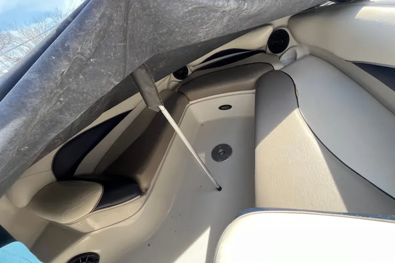 Slide: The Image of 2006 Tahoe 222 boat interior with cushioned seating and protective cover. - 20
