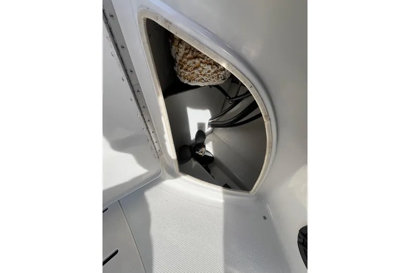 Slide: The Image of Open storage compartment in a 2006 Tahoe 222 boat, showing interior details. - 21