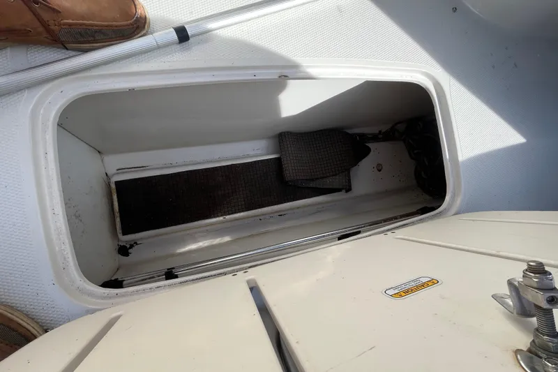 Slide: The Image of Open storage compartment on a 2006 Tahoe 222 boat, showing interior details. - 22