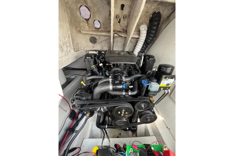 Slide: The Image of Engine compartment of a 2006 Tahoe 222 boat, showcasing detailed mechanical components. - 26