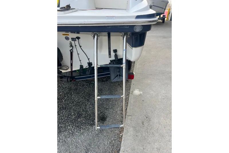 Slide: The Image of Rear view of a 2006 Tahoe 222 boat with a metal boarding ladder. - 6
