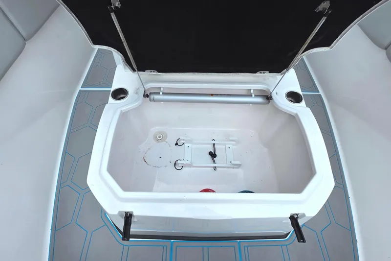 Slide: The Image of Open storage compartment on 2023 Sea Fox 288 Commander boat, featuring cup holders and sleek design. - 16