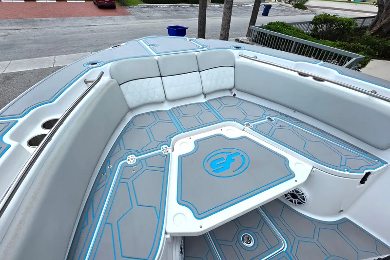 Slide: The Image of 2023 Sea Fox 288 Commander boat interior with cushioned seating and stylish flooring design. - 18