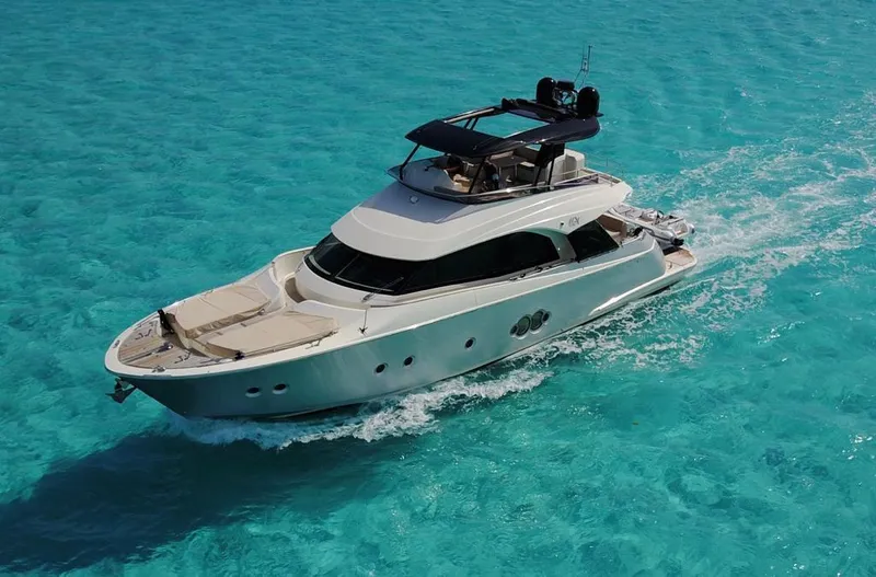 The Image of 2018 Monte Carlo Yachts MCY 65 cruising on clear turquoise water. - 0