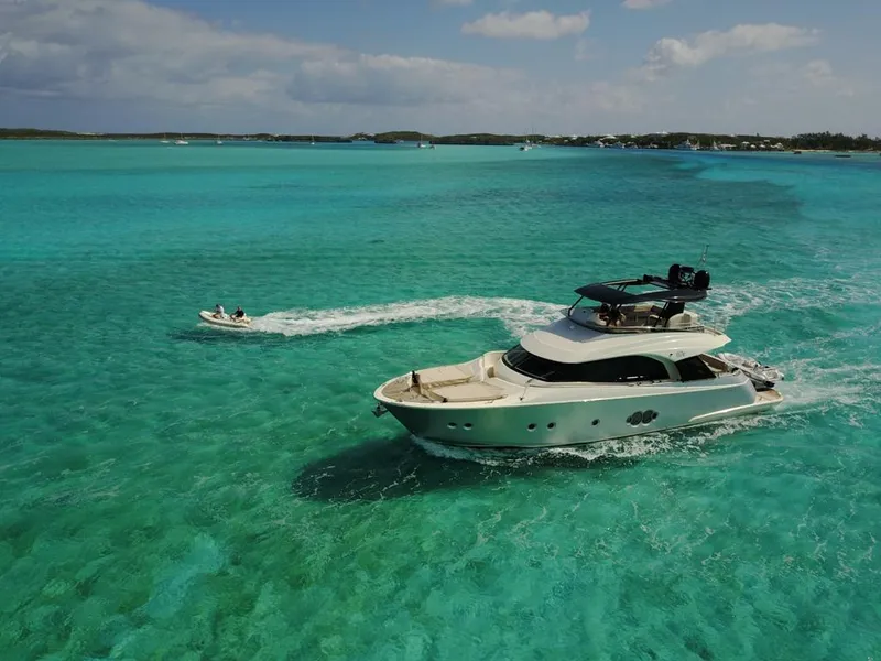 Slide: The Image of Monte Carlo Yachts MCY 65 (2018) cruising in clear turquoise waters. - 10
