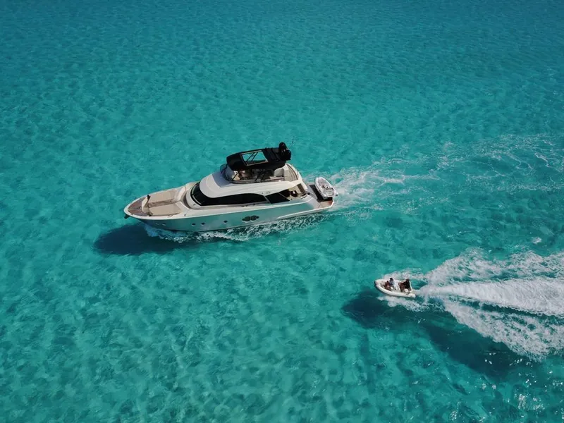 Slide: The Image of Aerial view of 2018 Monte Carlo Yachts MCY 65 cruising in clear turquoise waters. - 19