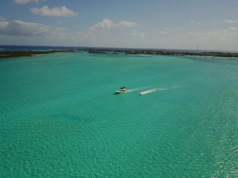 Slide: The Image of Aerial view of 2018 Monte Carlo Yachts MCY 65 cruising in turquoise waters. - 22