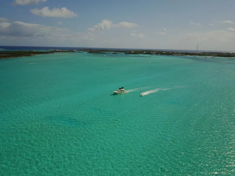 Slide: The Image of Monte Carlo Yachts MCY 65 (2018) cruising on turquoise waters under a clear sky. - 23
