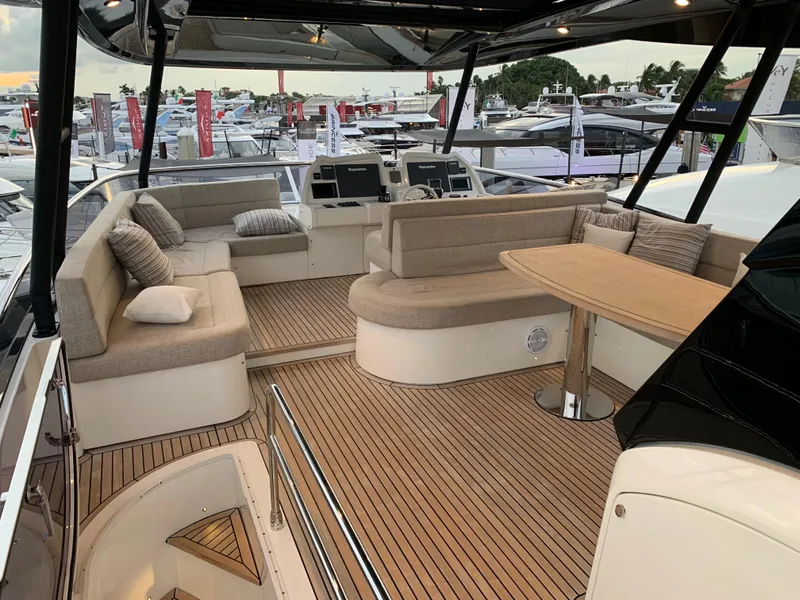Slide: The Image of Luxurious 2018 Monte Carlo Yachts MCY 65 flybridge with elegant seating and teak flooring. - 29