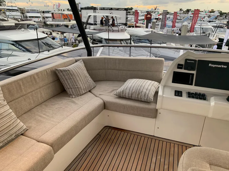 Slide: The Image of Luxurious seating area on 2018 Monte Carlo Yachts MCY 65, with marina view. - 32