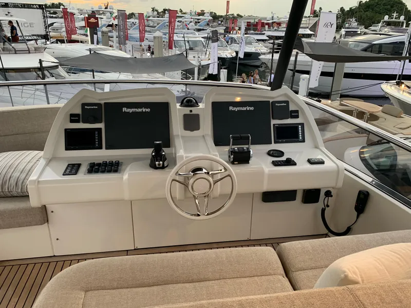 Slide: The Image of 2018 Monte Carlo Yachts MCY 65 helm station with Raymarine electronics at a marina. - 34