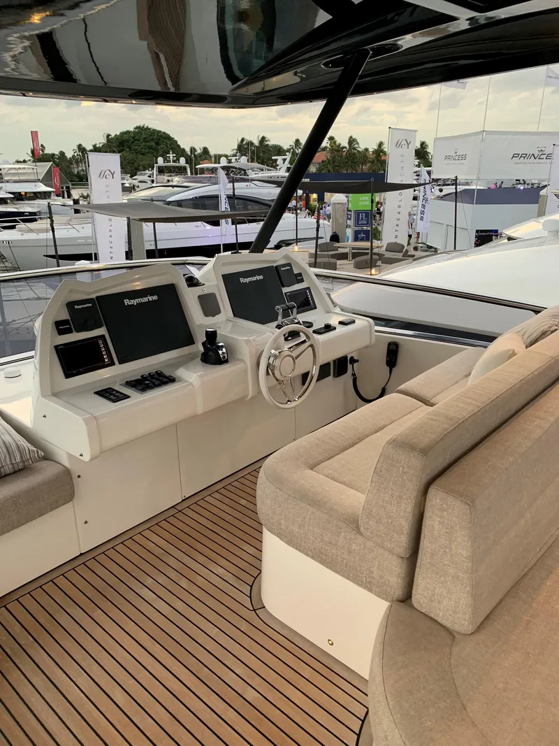 Slide: The Image of 2018 Monte Carlo Yachts MCY 65 helm station with modern navigation equipment and plush seating. - 35