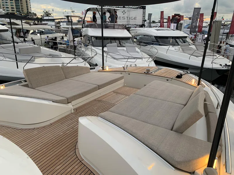 Slide: The Image of 2018 Monte Carlo Yachts MCY 65 luxury yacht with spacious deck seating at a boat show. - 36