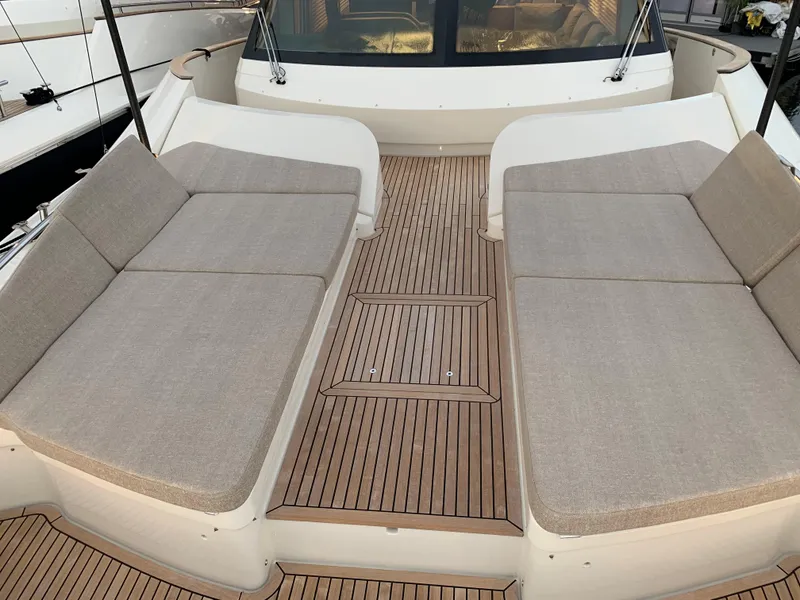 Slide: The Image of 2018 Monte Carlo Yachts MCY 65 deck with cushioned seating. - 37