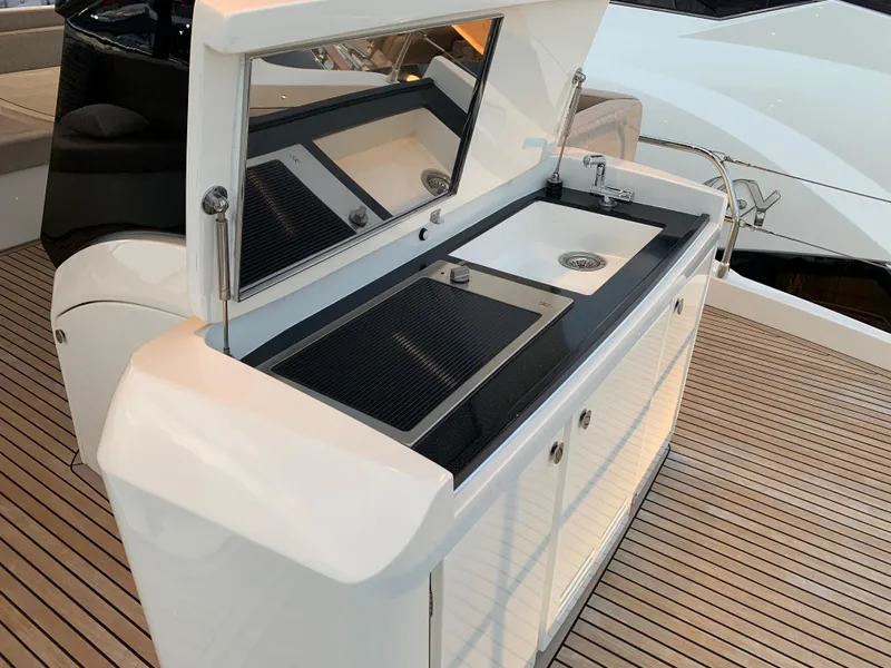 Slide: The Image of Outdoor kitchen on 2018 Monte Carlo Yachts MCY 65 with sink and grill. - 38