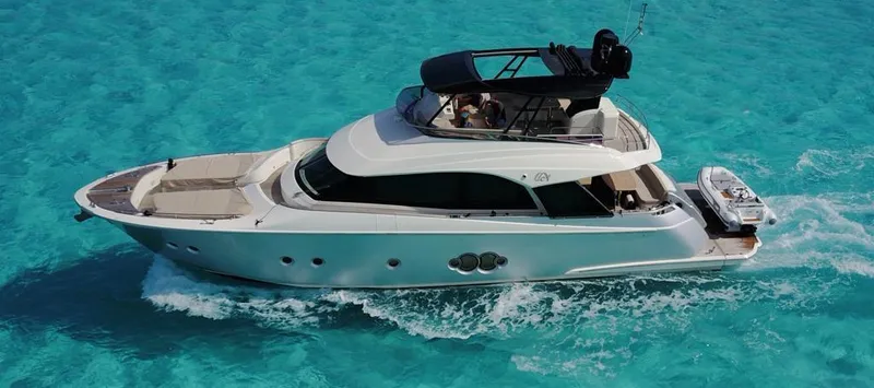 Slide: The Image of 2018 Monte Carlo Yachts MCY 65 cruising on clear turquoise waters. - 4