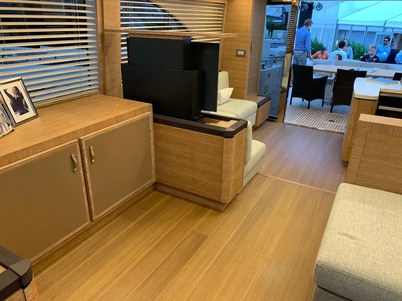 Slide: The Image of Interior of 2018 Monte Carlo Yachts MCY 65 with modern wood finishes and seating area. - 45