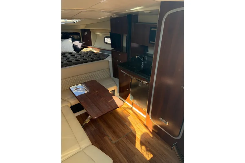 Slide: The Image of Interior of 2013 Chaparral 310 Signature boat with cozy seating and kitchenette. - 10