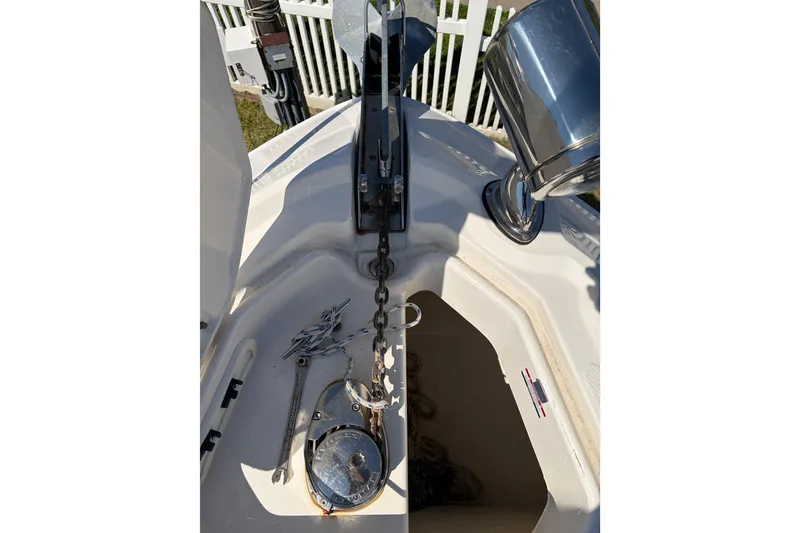 Slide: The Image of 2013 Chaparral 310 Signature boat anchor chain and storage compartment. - 12