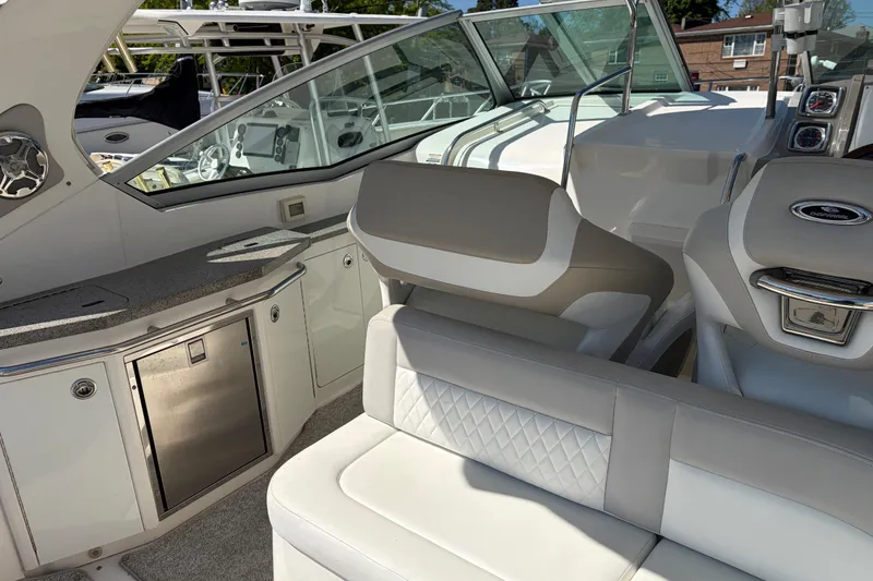 Slide: The Image of 2013 Chaparral 310 Signature boat interior with seating and kitchenette area. - 16