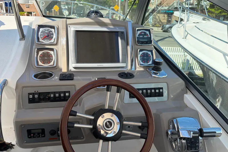 Slide: The Image of 2013 Chaparral 310 Signature boat dashboard with steering wheel, gauges, and Garmin GPS. - 17