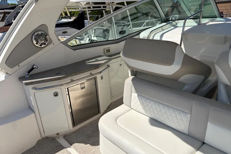 Slide: The Image of Interior of 2013 Chaparral 310 Signature boat with seating and kitchenette area. - 18
