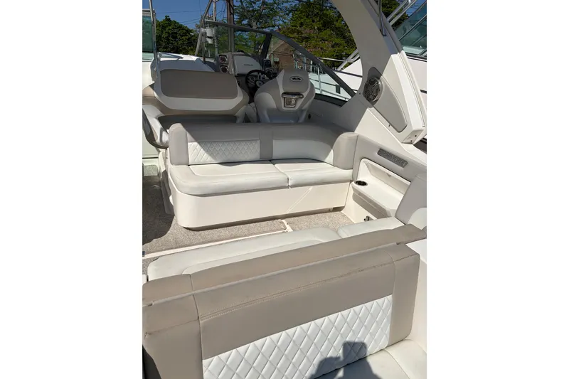 Slide: The Image of 2013 Chaparral 310 Signature boat interior with white leather seating and modern design. - 21