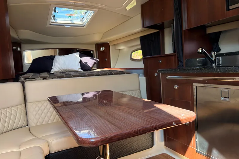 Slide: The Image of Interior of 2013 Chaparral 310 Signature boat with luxurious seating and kitchenette. - 9