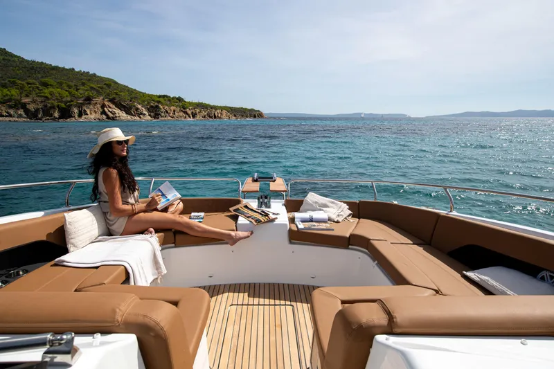 Slide: The Image of Woman relaxing on Jeanneau TH38 yacht, 2026 model, with scenic ocean view. - 7