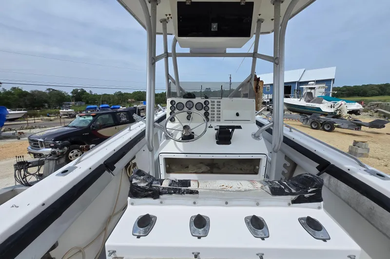 Slide: The Image of 1988 Baja 280 Sportfish boat interior with steering console, parked in a marina. - 5