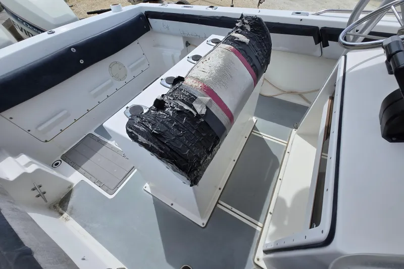 Slide: The Image of 1988 Baja 280 Sportfish boat interior with worn seating and steering wheel. - 9