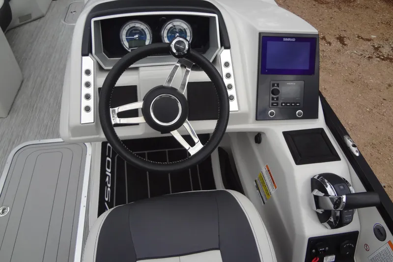 Slide: The Image of 2021 Baraletta Corsa 23 QSS boat dashboard with steering wheel and control panel. - 18