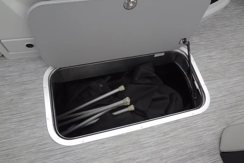 Slide: The Image of Open storage compartment in 2021 Baraletta Corsa 23 QSS boat, containing poles and fabric. - 38