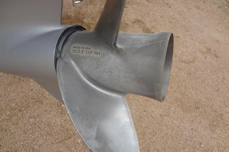 Slide: The Image of Close-up of a Baraletta Corsa 23 QSS 2021 boat propeller on sandy ground. - 45