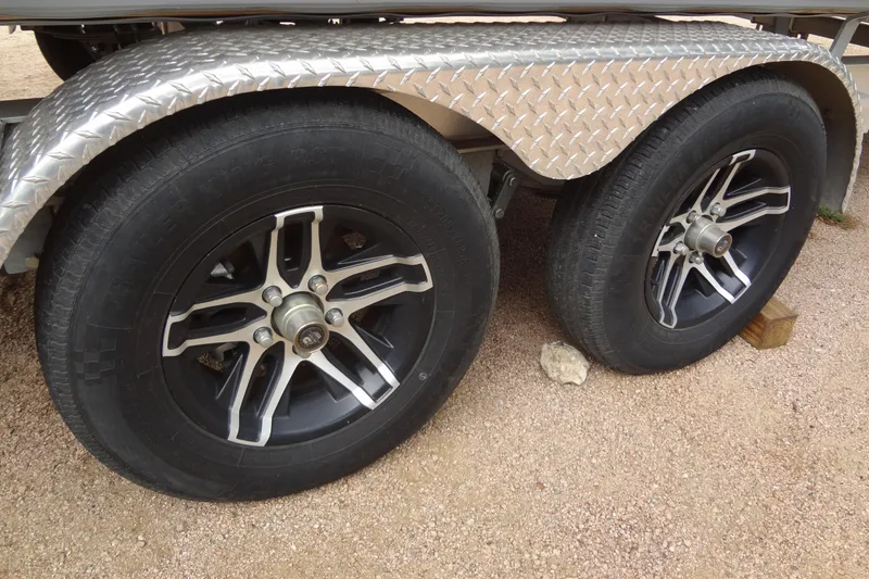 Slide: The Image of Dual wheels of a 2021 Baraletta Corsa 23 QSS trailer on gravel. - 49