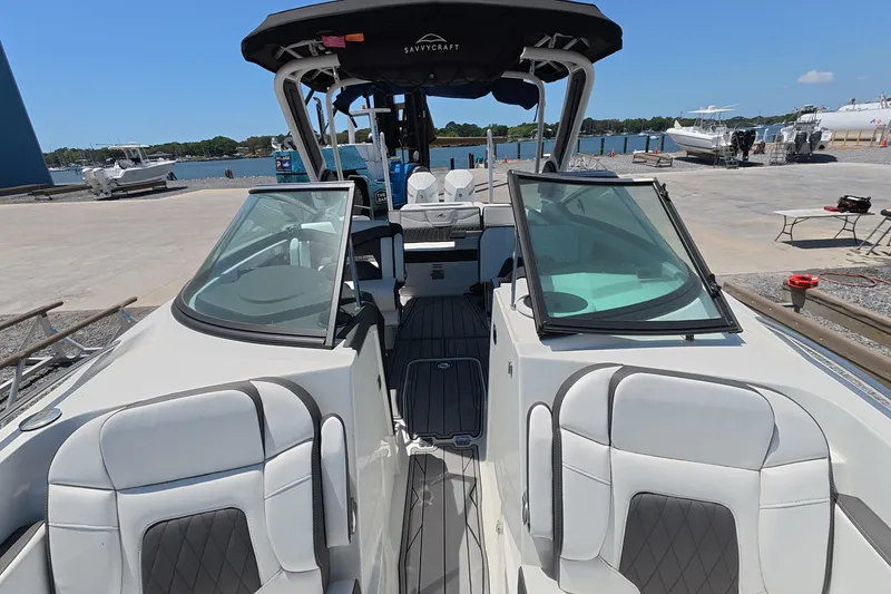 Slide: The Image of 2023 Monterey 305SS Super Sport boat with sleek interior design at a marina. - 6