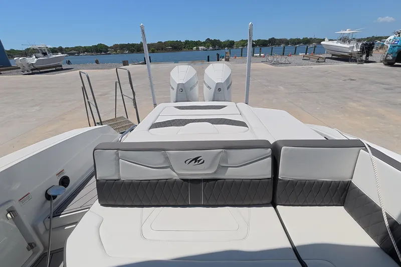 Slide: The Image of 2023 Monterey 305SS Super Sport boat with luxurious seating and dual Mercury engines. - 8