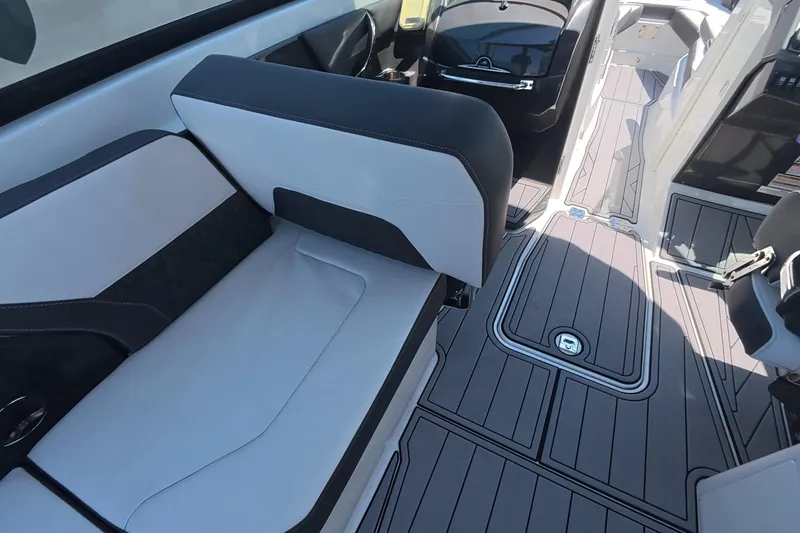 Slide: The Image of 2023 Monterey 305SS Super Sport boat interior with sleek seating and modern flooring design. - 19