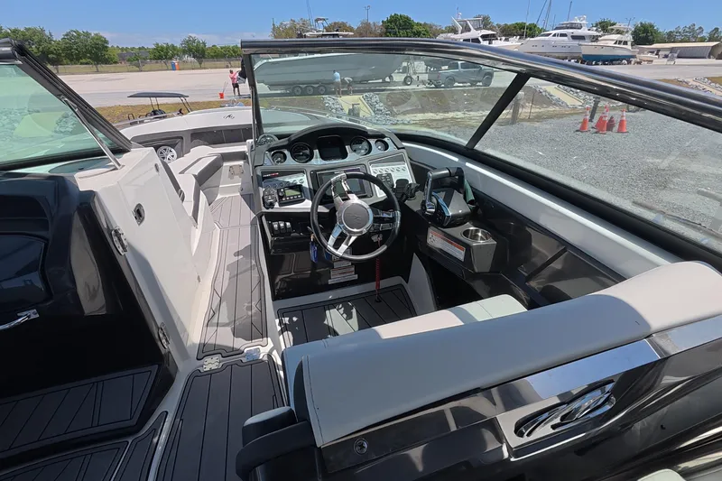 Slide: The Image of 2023 Monterey 305SS Super Sport boat interior with modern dashboard and steering wheel. - 9