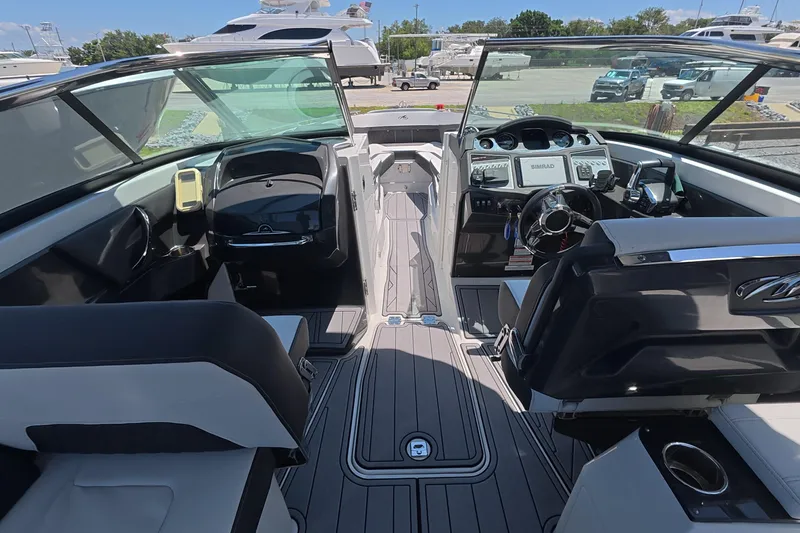 Slide: The Image of 2023 Monterey 305SS Super Sport boat interior with modern dashboard and seating. - 21