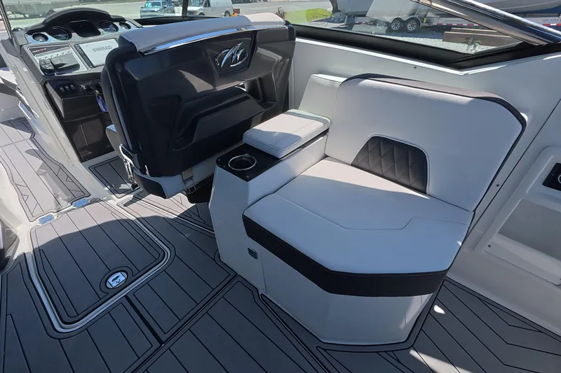 Slide: The Image of 2023 Monterey 305SS Super Sport boat interior with sleek seating and modern dashboard design. - 24