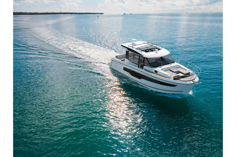 The Image of 2026 Jeanneau NC 1095 Coupe Series 2 cruising on clear blue water. - 0