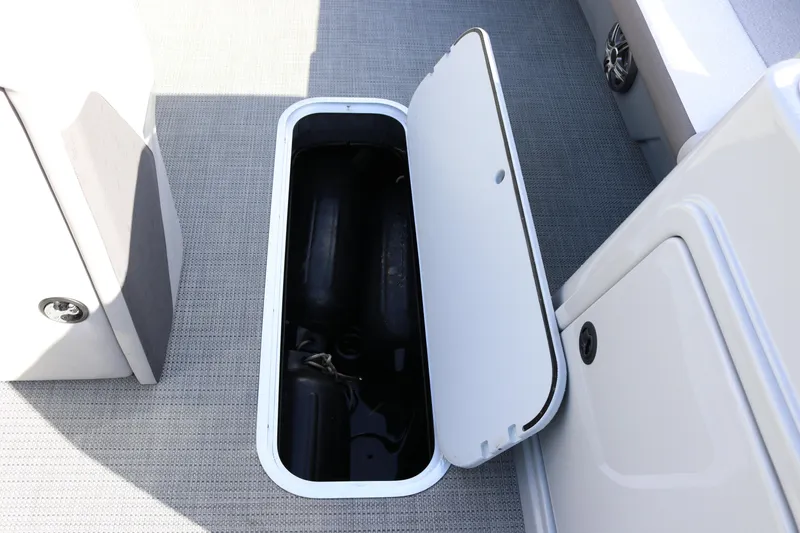 Slide: The Image of Open storage compartment on 2024 SunChaser Eclipse LR DH 25 Demo boat. - 11