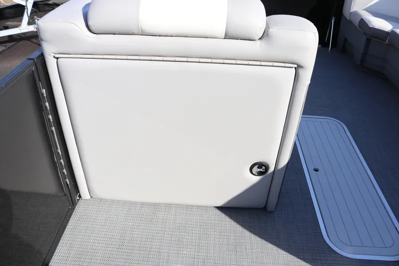 Slide: The Image of 2024 SunChaser Eclipse LR DH 25 Demo boat interior with cushioned seating and storage compartment. - 16