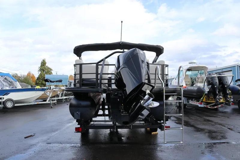 Slide: The Image of 2024 SunChaser Eclipse LR DH 25 Demo pontoon boat with outboard motor, rear view. - 2